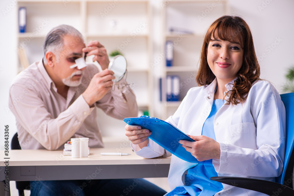 Old man visiting young female doctor for plastic surgery