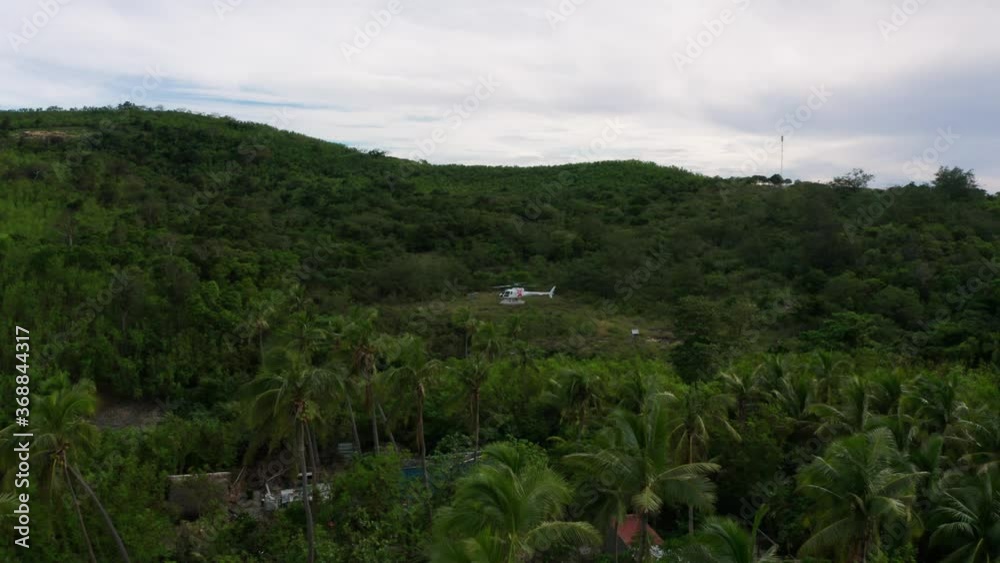 Helicopter On The Vast Greenery In Fiji On A Cloudy Day - aerial Helicopter On The Vast Greenery In Fiji On A Cloudy Day - aerial