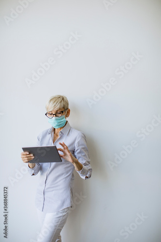 Mature businesswoman using ...