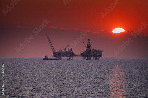 Oil platform with sunset