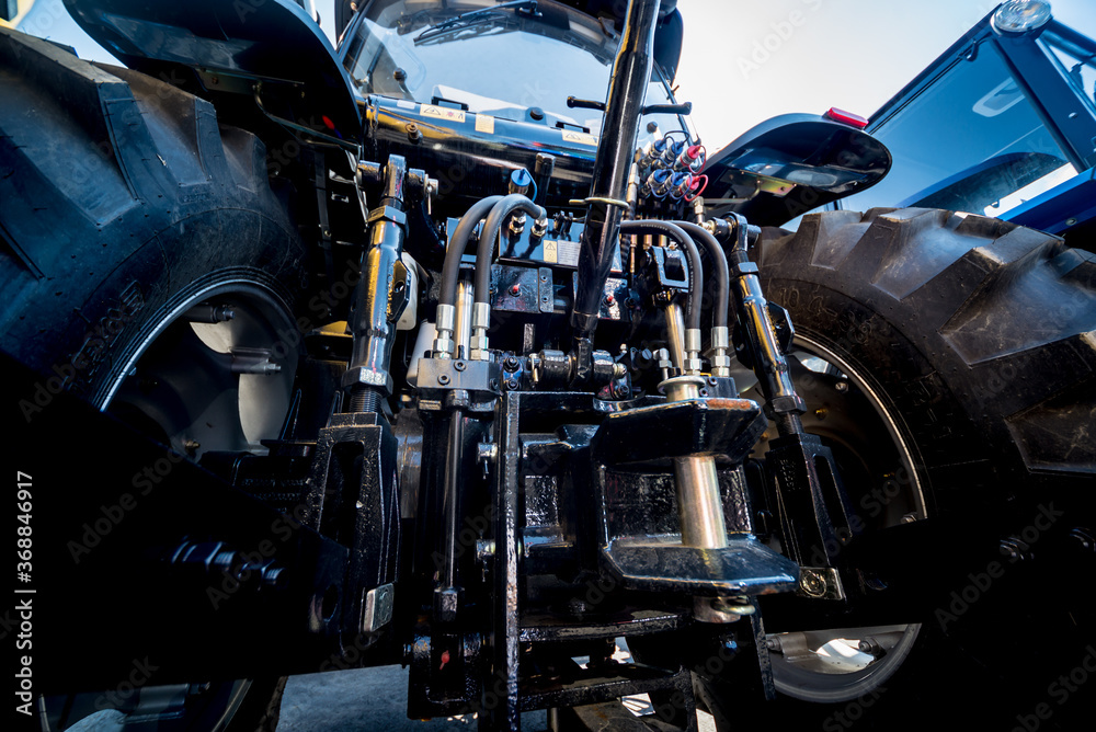 Rear view of modern agricultural tractor. Industrial details.