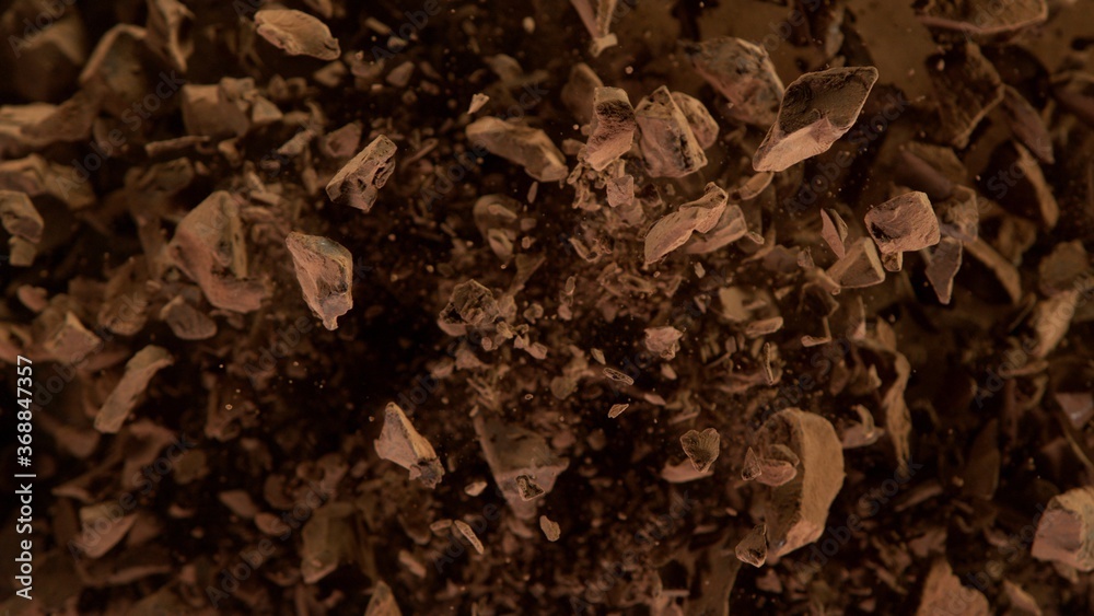 Freeze motion of flying group of raw chocolate pieces. Freeze motion of flying group of raw chocolate pieces.