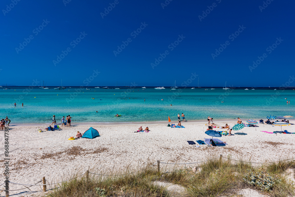 ES TRENC, Majorca, Spain - 25 JULY 2020 - People enjoying summer day on hotspot beach in Majorka. ES TRENC, Majorca, Spain - 25 JULY 2020 - People enjoying summer day on hotspot beach in Majorka.