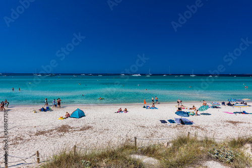 ES TRENC, Majorca, Spain - 25 JULY 2020 - People enjoying summer day on hotspot beach in Majorka.