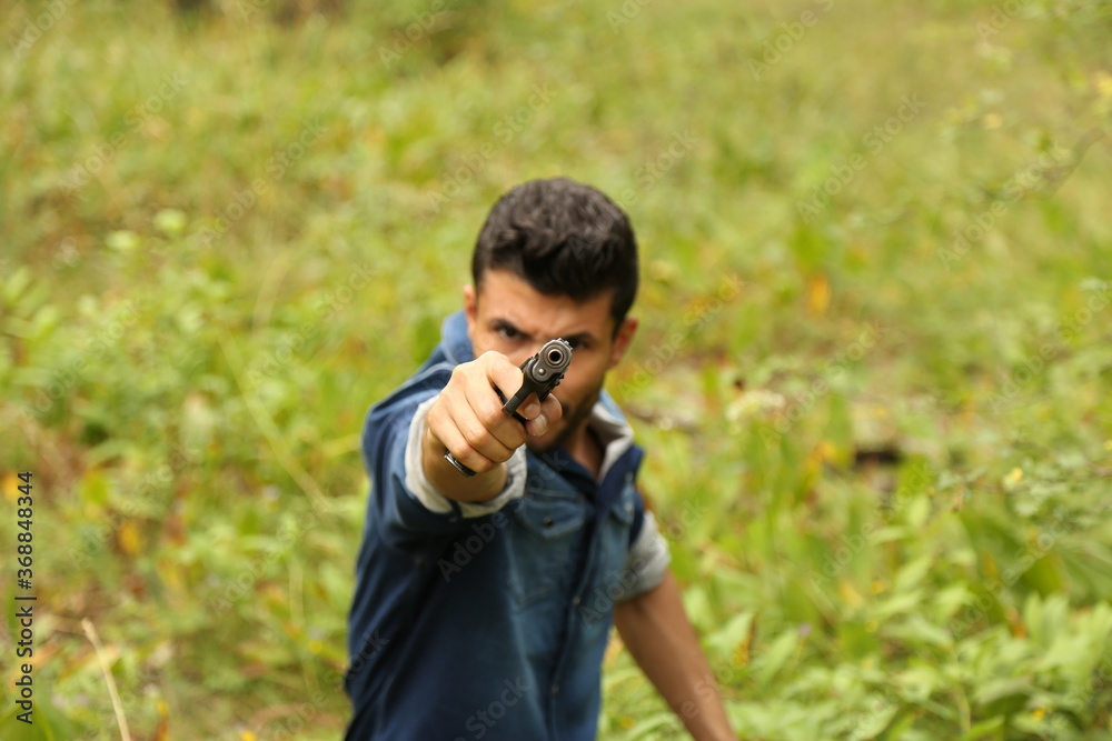 The barrel of a pistol in the hands of a man The barrel of a pistol in the hands of a man