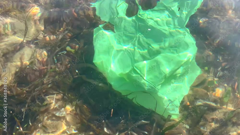 Ocean plastic pollution concept with used old plastic bag floating in ...