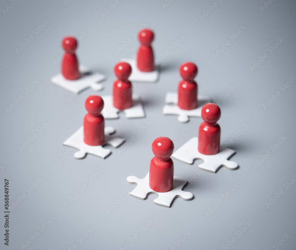 Obraz premium Wooden people standing on puzzles ,human resources and management concept,teamwork