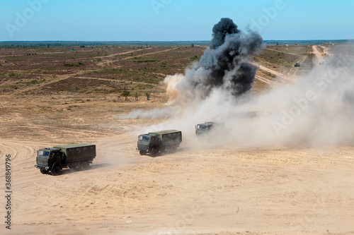 Photos Military convoy trucks are driving on the road