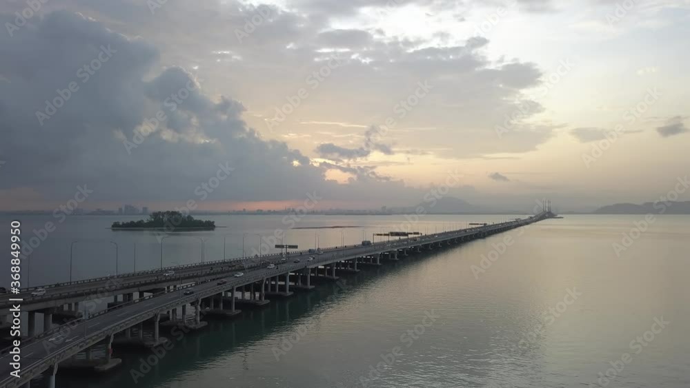 Aerial view ascending and look down car traffic at Penang Bridge in sunrise morning. Aerial view ascending and look down car traffic at Penang Bridge in sunrise morning.