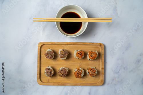 Sushi served on bamboo dishes with soya sauce