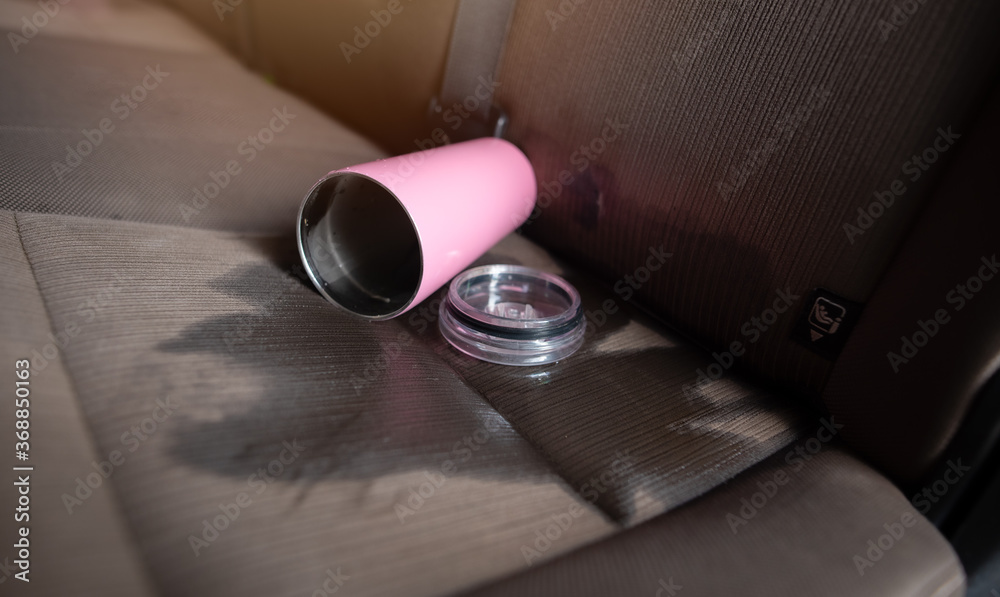 Glass of water spilled on the car backseats 스톡 사진