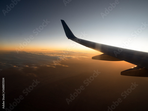 Travel by air. View from the wing of the aircraft at sunsets, sunrises, clouds.