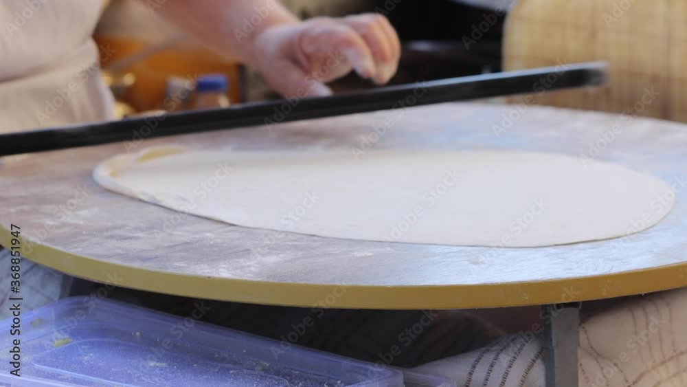 Making gozleme dough by close up female hands in kitchen. Shaping dough is precursor to making a wide variety of food stuffs, particularly breads.