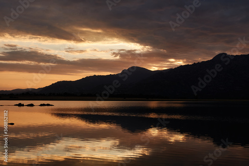 Sunset in the Santillana Reservoir with La Pedriza and the Sierra de Guadarrama in the background. Madrid s community. Spain