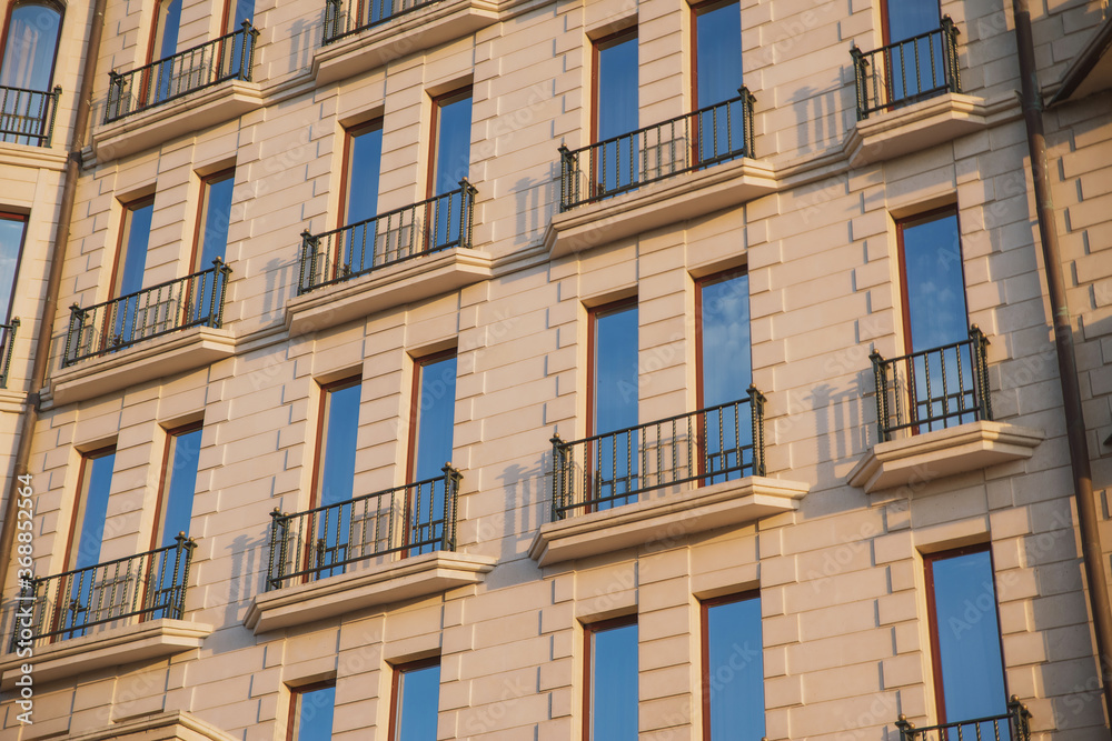 warm tones building texture with blue sky reflection in windows