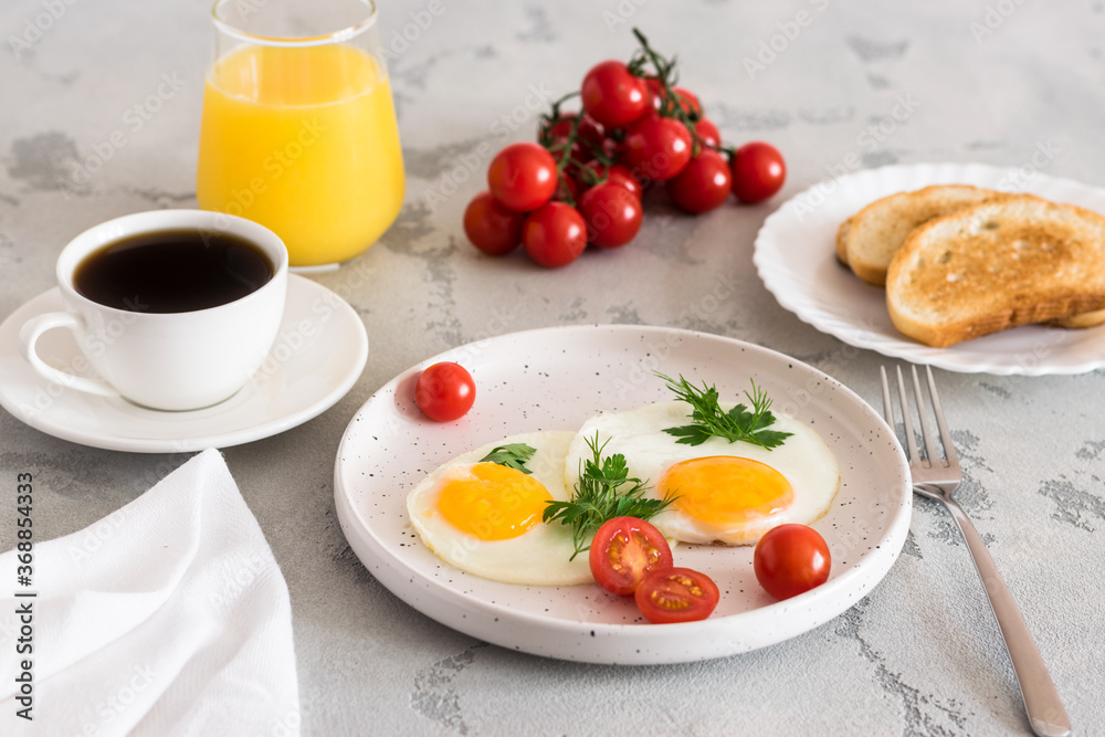 fried eggs with tomatoes and herbs, toast, coffee and juice fried eggs with tomatoes and herbs, toast, coffee and juice