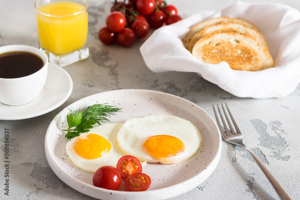 fried eggs with tomatoes and herbs, toast, coffee and juice fried eggs with tomatoes and herbs, toast, coffee and juice