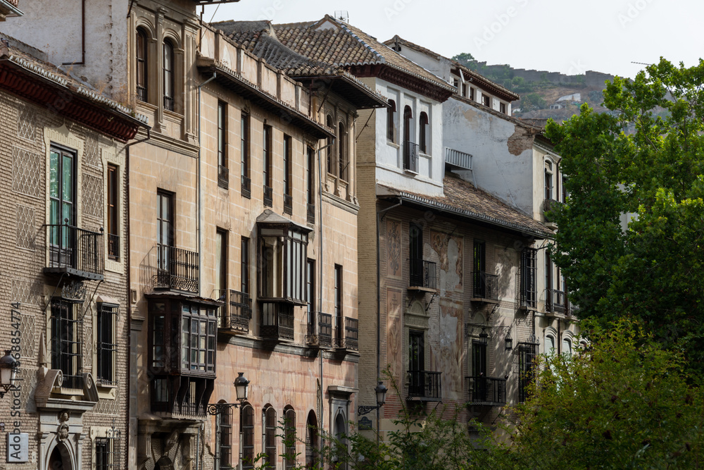 Facades of old houses in the Carrera del Darro one summer morning in Granada