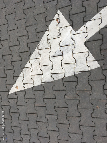 White arrow on road tile