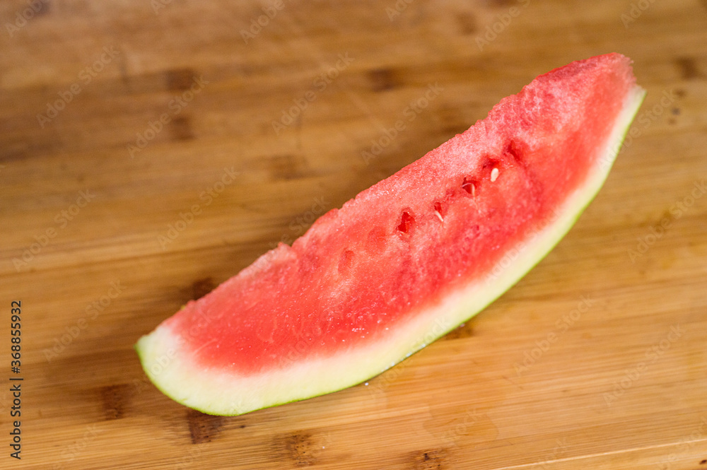Slice of watermelon on wooden board