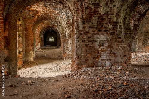 Brick corridor on the lower level in an old abandoned and decaying building