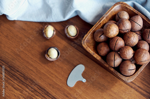 Macadamia nuts on a wooden table and linen towel