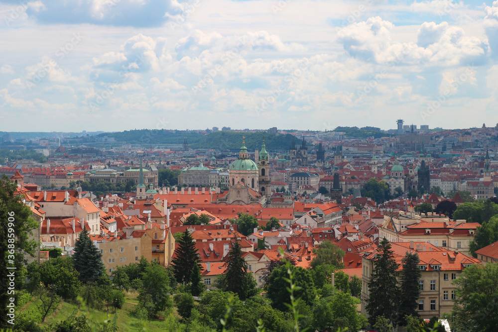 Panorama of the historical center of Prague from the Charles bridge to the old town square on a hot summer day under the clouds.