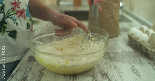 Wallpaper Mural Female hands mix ingredients for dough in a glass bowl by wire whisk. Close up Torontodigital.ca