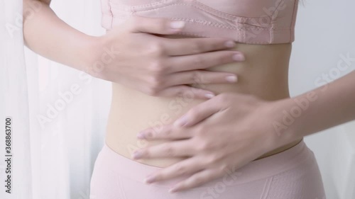 Wallpaper Mural Beautiful young asian woman in underwear applying cream and lotion on belly, beauty girl diet and weight loss is slim applying message body care, treatment and cosmetic with moisturizer. Torontodigital.ca