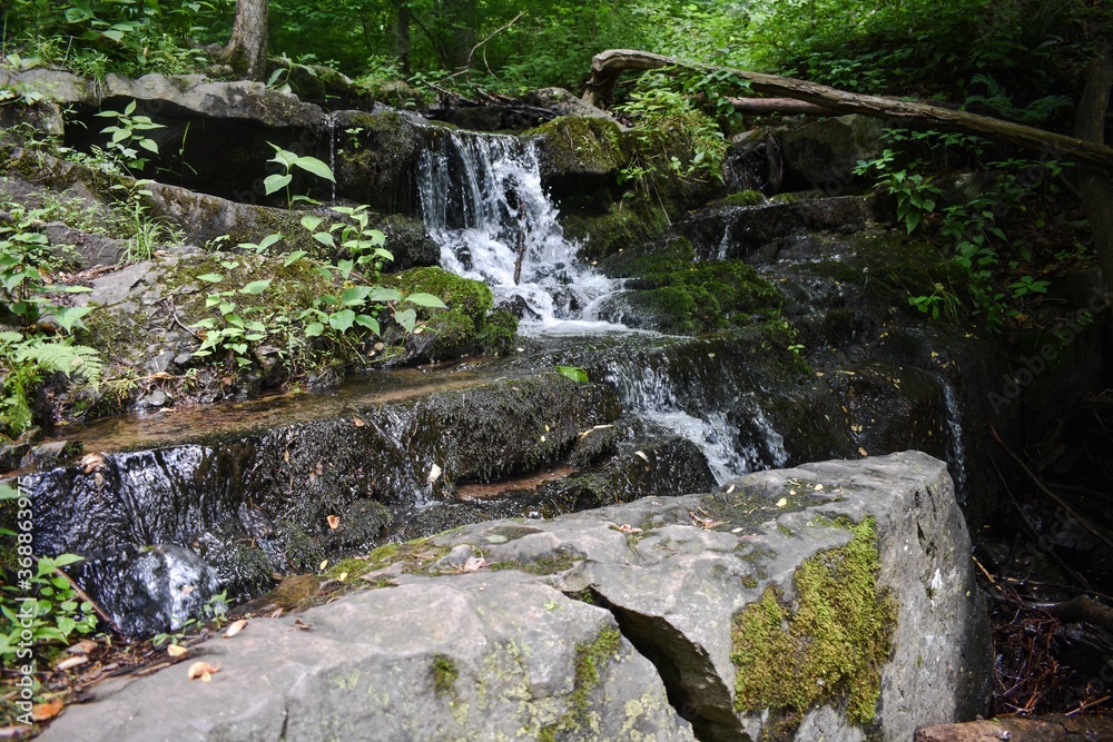 A Small Waterfall Flowing Over Rocks A Small Waterfall Flowing Over Rocks
