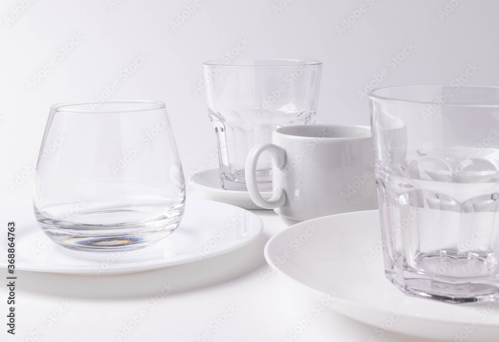 a group of different white ceramic plates on white background