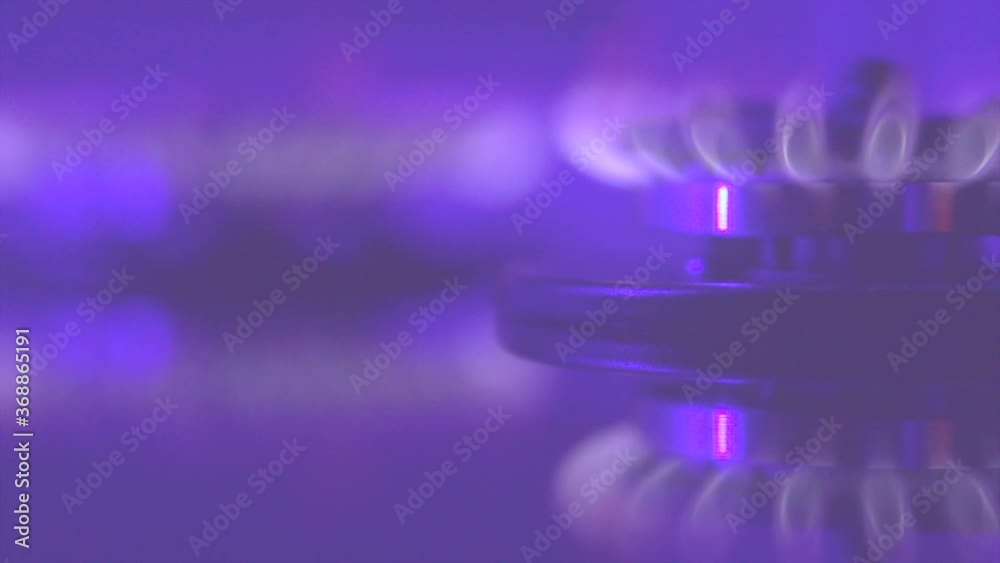 Gas blue flame. Gas stove on black background. Closeup of burning natural gas. Cooker. Fire on