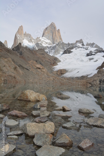 rocky landscape with a mirrored mountain on a lake and a rocks tower. Laguna de los Tres, Mount Fitz Roy, Patagonia, Argentina