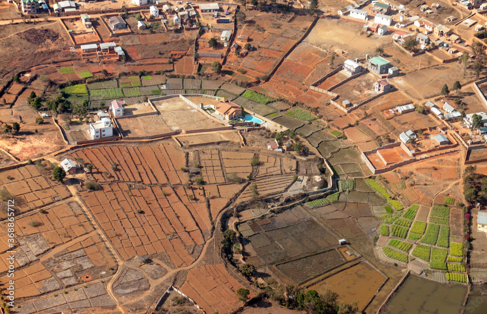 Fototapeta premium Eastern Madagascar: aerial view of green valley in a dry and red environment
