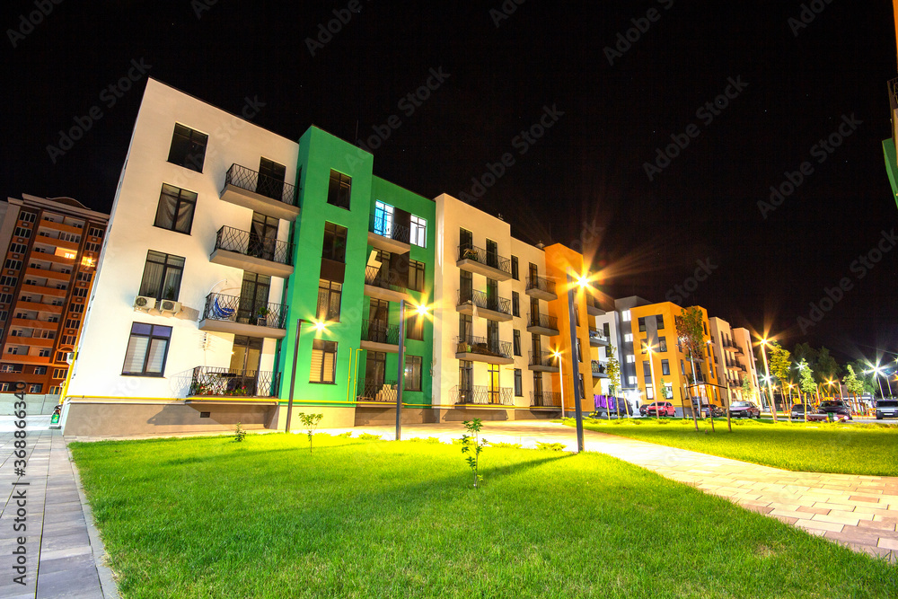 Picture of Yard between residential apartment buildings with green grass lawns and ...