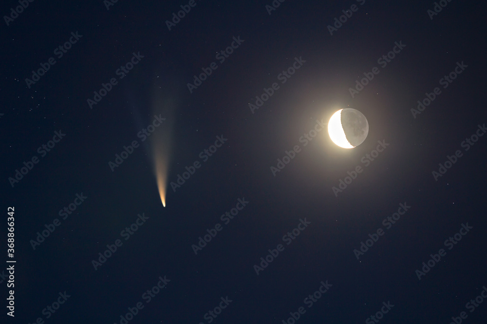 Night blue sky with bright moon and C/2020 F3 (NEOWISE) comet with light tail. Night blue sky with bright moon and C/2020 F3 (NEOWISE) comet with light tail.
