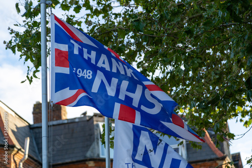 flags on a flag pole with the words thanks NHS on them during the coronavirus or Covid-19 pandemic