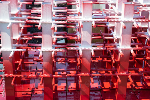 Red and white steel reinforcement for reinforced concrete.texture of a steel reinforcing bar on a construction site.