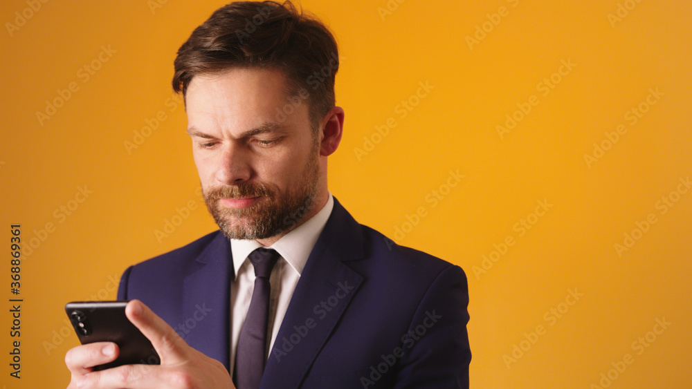 Managing a business with his smartphone. Bearded caucasian businessmen sending sms. High quality photo Managing a business with his smartphone. Bearded caucasian businessmen sending sms. High quality photo