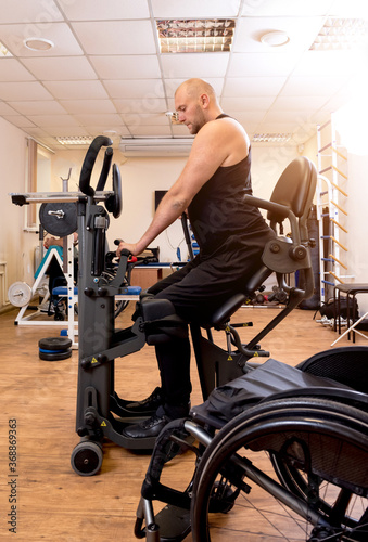 Disabled man training in the gym. Rehabilitation center