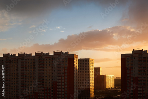 Sunset landscapes of the city. Dark silhouettes of houses against the sunset. Yellow sunset.
