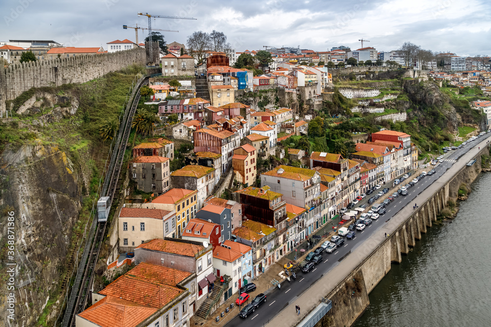Porto, Portugal. View of embankment of Douro river, the old houses and funicular (cable railway) on the hill.