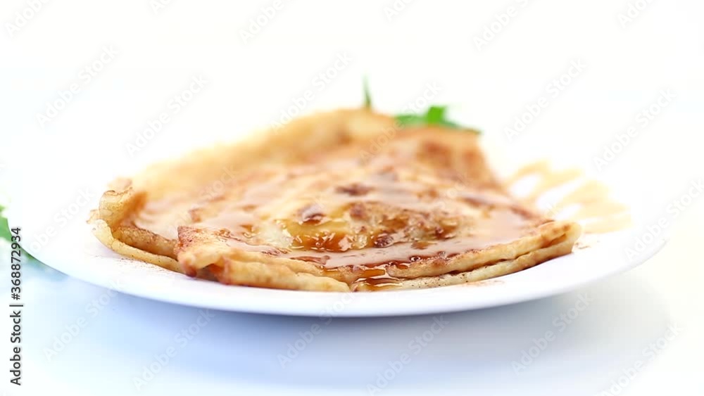 fried thin pancakes with sweet caramel in a plate fried thin pancakes with sweet caramel in a plate
