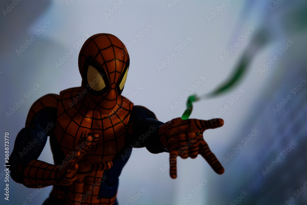 Naklejka premium NEW YORK USA - AUGUST 2 2020: Scene with Marvel comic superhero Spiderman shooting a web - Hasbro Marvel Legends figure
