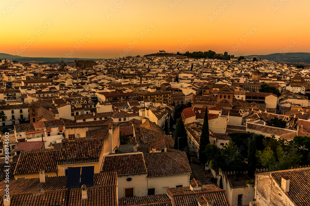 A panorama view across the rooftops of Antequera, Spain at sunset on a summers evening