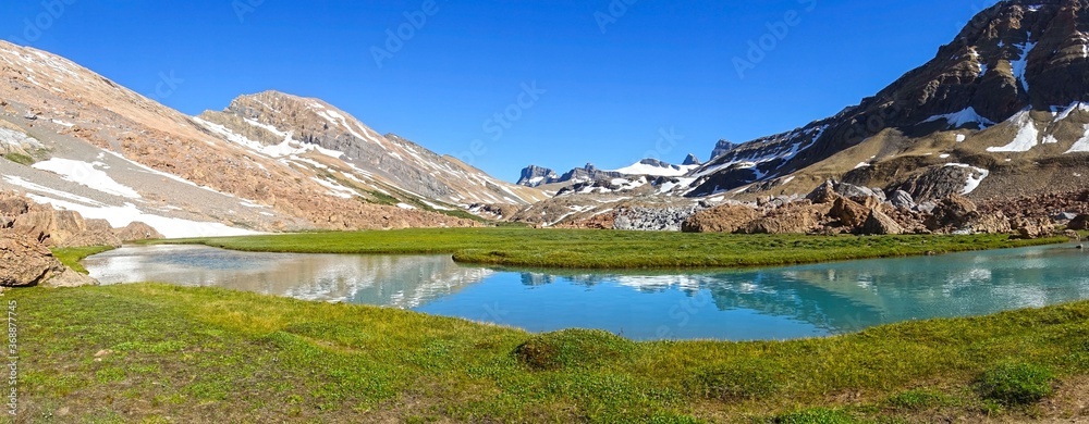 Wide Panoramic Landscape of Brazeau River Calm Blue Water with Scoured Rock Canyon and Distant Rocky Mountain Peaks of White Goat Wildernes, Alberta Canada