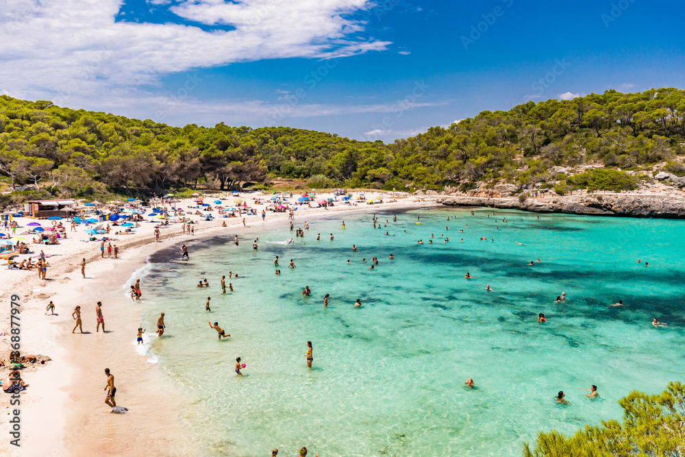 CALA MONDRAGO, Majorka, Spain, 24 July 2020 - People enjoy the beach in summer, Parque Natural de Mondrago. Santanyi. Malorca. Spain CALA MONDRAGO, Majorka, Spain, 24 July 2020 - People enjoy the beach in summer, Parque Natural de Mondrago. Santanyi. Malorca. Spain