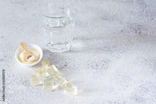 Fotografie Gelatin, agar-agar, gelatinous mass (cubes in the form of crystals) on a gray background