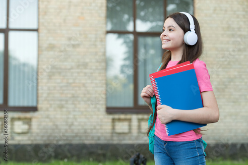 Teen girl school student with stereo headphones new technology, according to nowadays concept