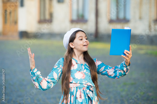 Girl student inspired reading recite poetry, literature lesson concept photo